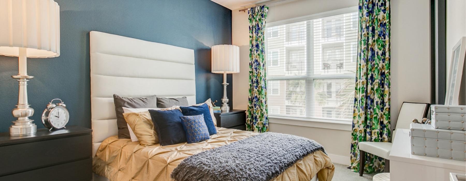 a bedroom with a bed and a fan
